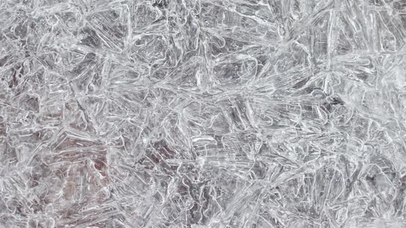 Cracked Ice Texture with Frozen Autumn Leaves Closeup Slow Motion