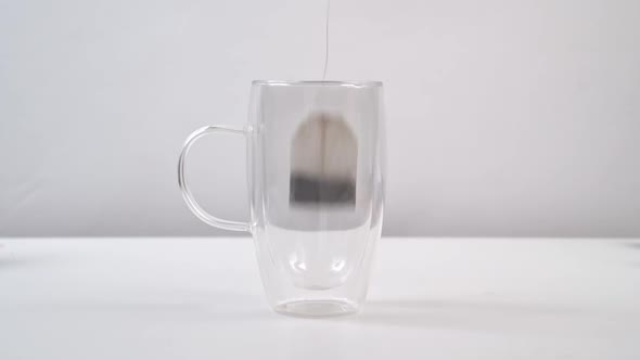 In a Large Glass Mug with Double Glass of Hot Water Brew Tea Bag