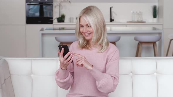 Excited Happy Mature Old 60s Woman Winner Holding Smartphone Using Mobile App Winning Online Lottery