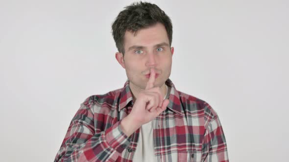 Portrait of Young Man with Finger on Lips Silence