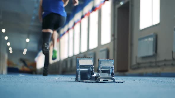 Person with Bionic Prosthesis Stands in a Pose and Starts To Run