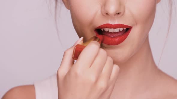 Close-up of Girl Applying Red Lipstick