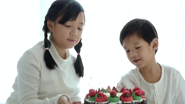 Asian Brother Feeding A Cake For His Sister