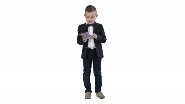 Little Boy in a Suit Counting Money on White Background