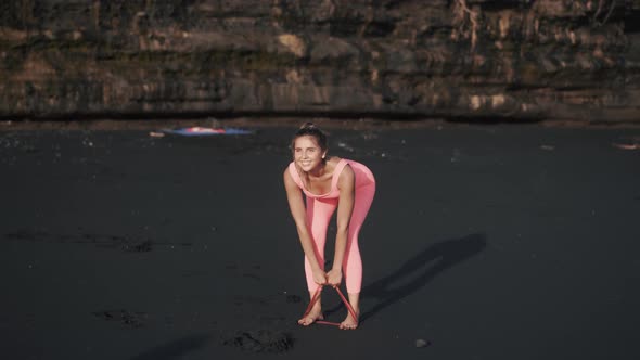 Front View Camera in Motion of Young Woman Doing Exercises Under the Rock