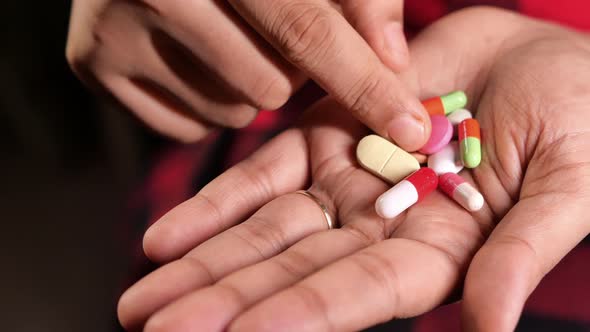 Close Up of Women Hand Taking Pills 