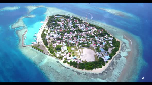 Aerial top down nature of paradise coast beach lifestyle by clear ocean with bright sandy background