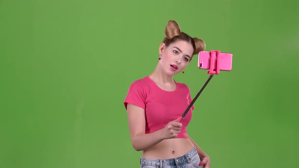 Girl Doing Selfie on Selfie Stick. Green Screen. Slow Motion