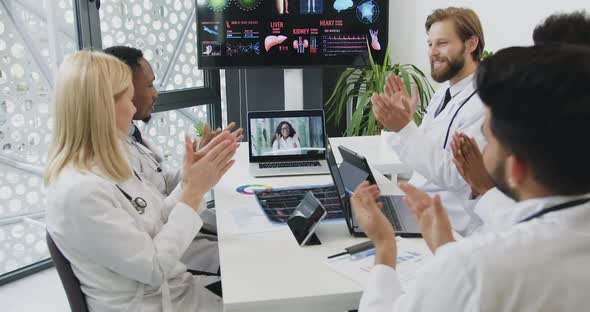 Doctors Greeting with Applauses Each Other After Successful Ending Online Video Conference