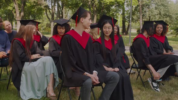 Diverse Multiethnic Students Chatting During Graduation Ceremony