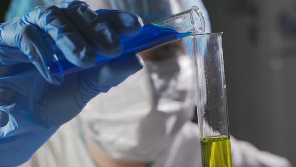 Chemical Laboratory. People Conduct Chemical Experiments.the Scientist with the Pipette Analyzes.