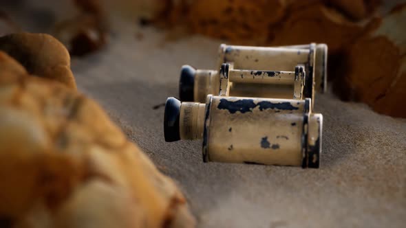 Old German Military Binoculars on the Sand Beach alt