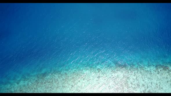 Aerial top down sky of luxury coastline beach vacation by transparent lagoon with white sandy backgr