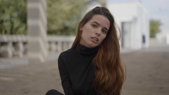 Young Woman Outdoors Moves Head While Looking Into Camera Close Slomo