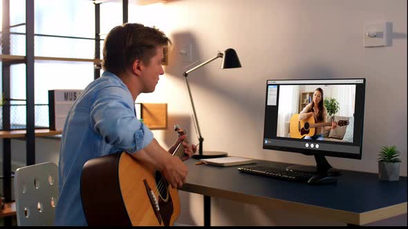 Man Learning To Play Guitar Online at Home