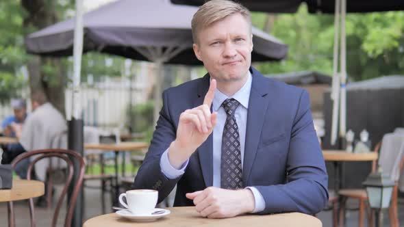 No, Rejecting Gesture by Businessman, Sitting in Outdoor Cafe