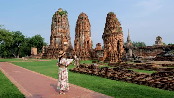 Ayutthaya Thailand at Wat Mahathat Women with a Hat and Tourist Map Visiting Ayyuthaya Thailand