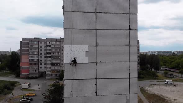 Industrial Alpinism. Aerial View. Work on Outer Insulate Building with Styrofoam