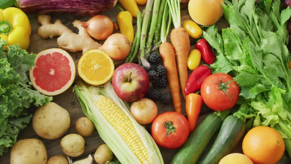 Video of fresh fruit and vegetables over wooden background