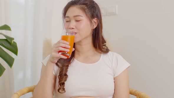 Healthy Young Asian woman Drinking Carrot juice for vitamin A and high in vitamins C