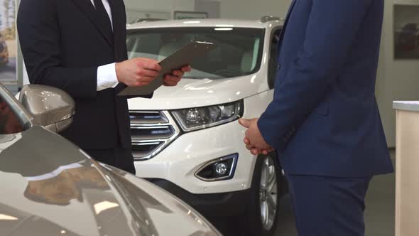 Sales Manager Sells Car To the Customer at the Dealership