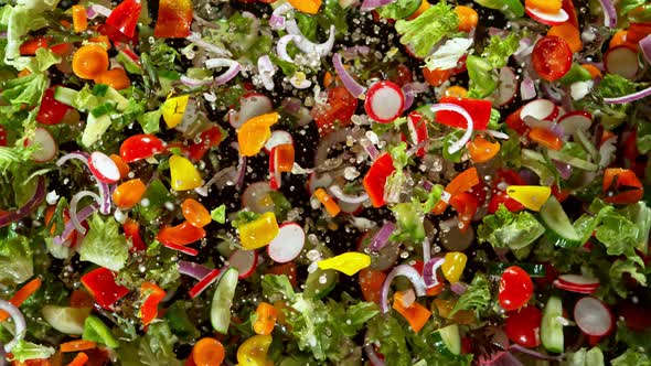 Super Slow Motion Shot of Flying Cuts of Colorful Fresh Vegetables and Water Drops at 1000Fps.