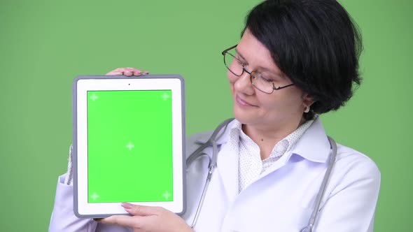 Beautiful Woman Doctor with Short Hair Showing Digital Tablet