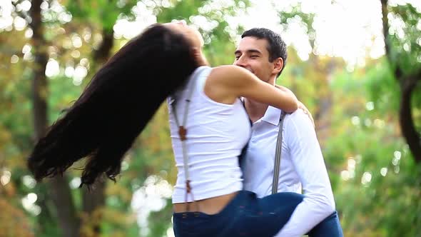 Teen couple hugging in the park in autumn time