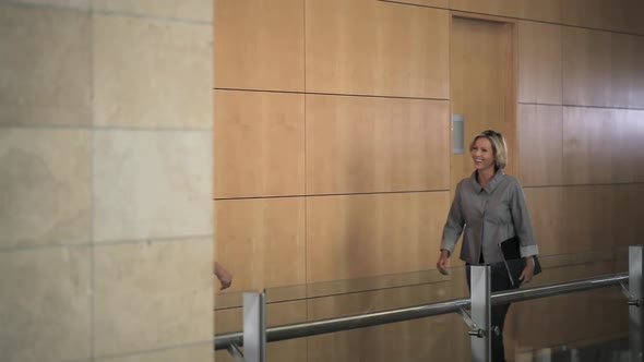 Businesswomen meeting in corridor and embracing