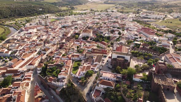 Rotating aerial shot of the historic city center of Silves in the Portuguese region of Algarve.