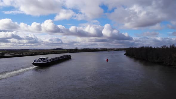Aerial View Of Barge With Backwash On Oude Maas River During Daytime In South Holland, Netherlands.