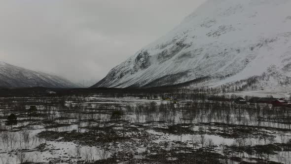 Flying over a snow covered forest in a desolate valley. Troms, Finnmark norhern Norway.4k drone sho