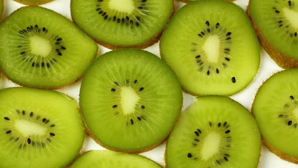 Top view Rotate of Transparent Slice of kiwi fruit on white background, Close up fresh kiwi sliced