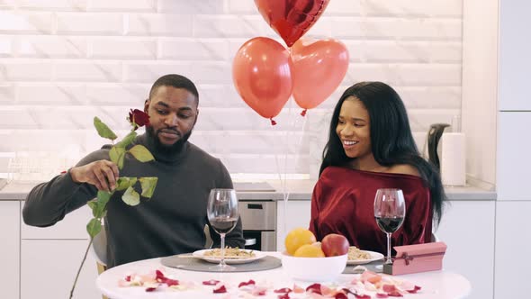 Young Couple Having Dinner at Home and Celebrating Saint Valentine