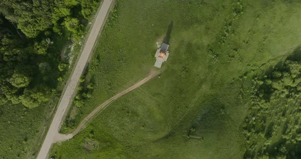 Down aerial shot of the St. George church and a road located in Didgori Valley.