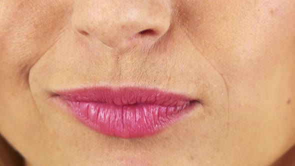 A Woman Puckers Her Lips - Closeup