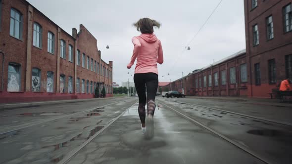 Woman Running in the Middle of the Street