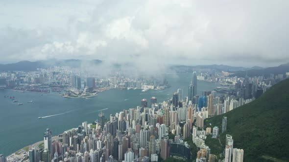 Aerial perspective though clouds of Victoria Habour, Hong Kong skyscrapers Island District