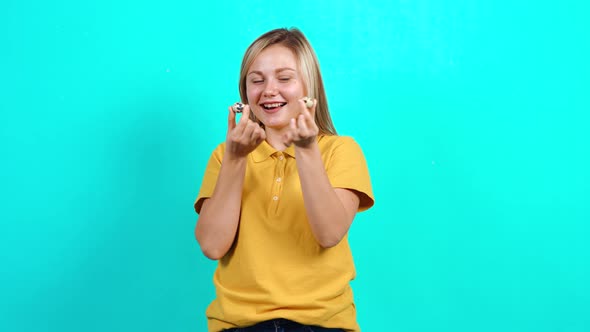 The Young Woman Holding Two Quail Eggs in Her Hands, Promoting the Small Business