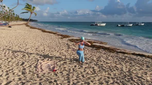 Fit Woman is Exercising at the Beach in the Morning Tropical Vacation