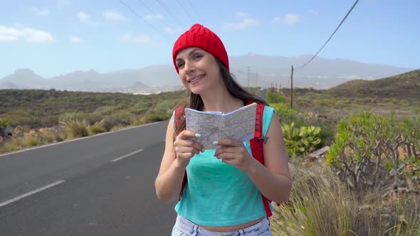 Traveler Woman Hitchhiking on a Sunny Road and Walking