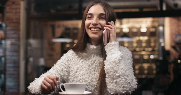 Girl Talking on Phone in Cafe