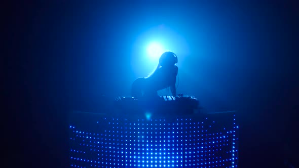 Blond Girl Dj Sexy Dancing in Blue Silhouette