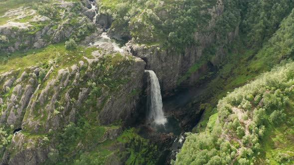 Drone Over Waterfall In Lush Valley