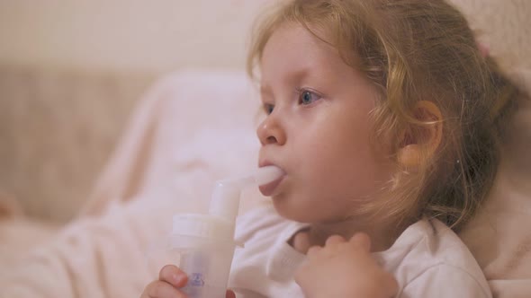Curly Girl Undergoes Procedure with Inhaler for Cold in Bed
