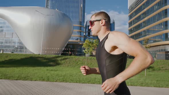 Pro Runner Runs on a City Road Athlete Trains in an Urban Environment on a Sunny Day Modern Urban