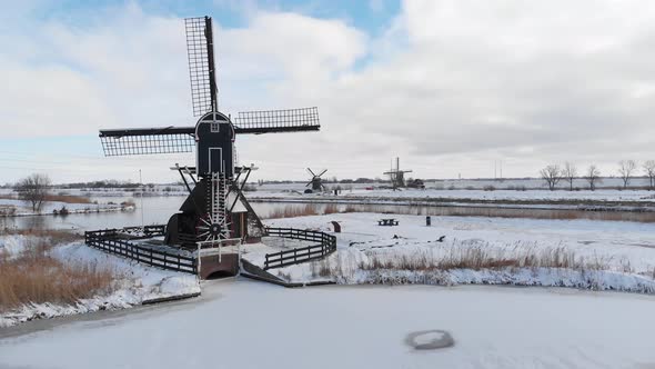 Aerial: Netherlands windmills and frozen canals in winter snow