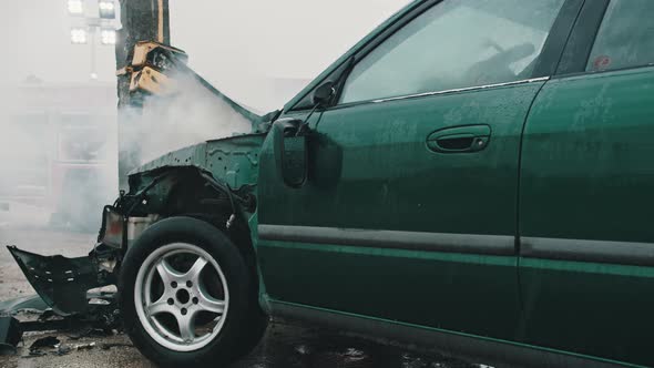 Close Up, Smoke From Wrecked Car with Fire Engine in the Background. Car Accident