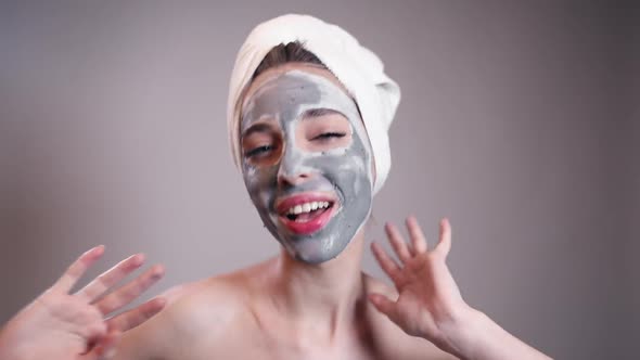 Excited Girl with Face Covered in Clay Having Fun