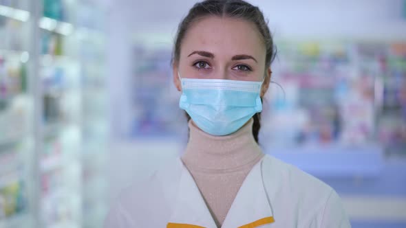 Live Camera Zoom Out As Positive Woman in Coronavirus Face Mask and Uniform Gesturing Thumb Up